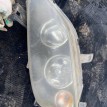 Фара левая Mazda Demio IDY (2002—2007) Mazda 2 оригинальный номер p2632L