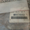 Пыльник двигателя Митцубиси Лансер 9 Mitsubishi La Mitsubishi i оригинальный номер MR974002