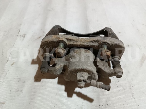 Суппорт тормозной передний левый Nissan NV200 