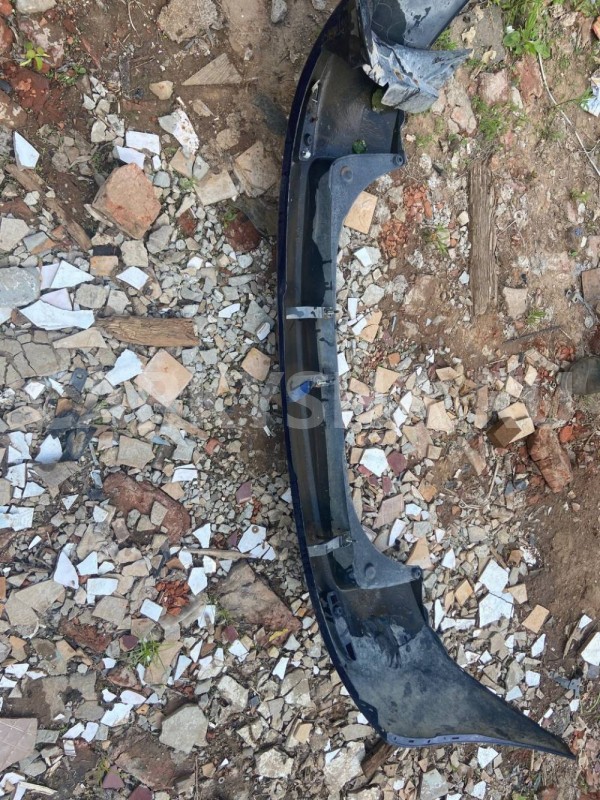 Бампер задний Mazda Demio IDY (2002—2007) Mazda 2 оригинальный номер D5215022110